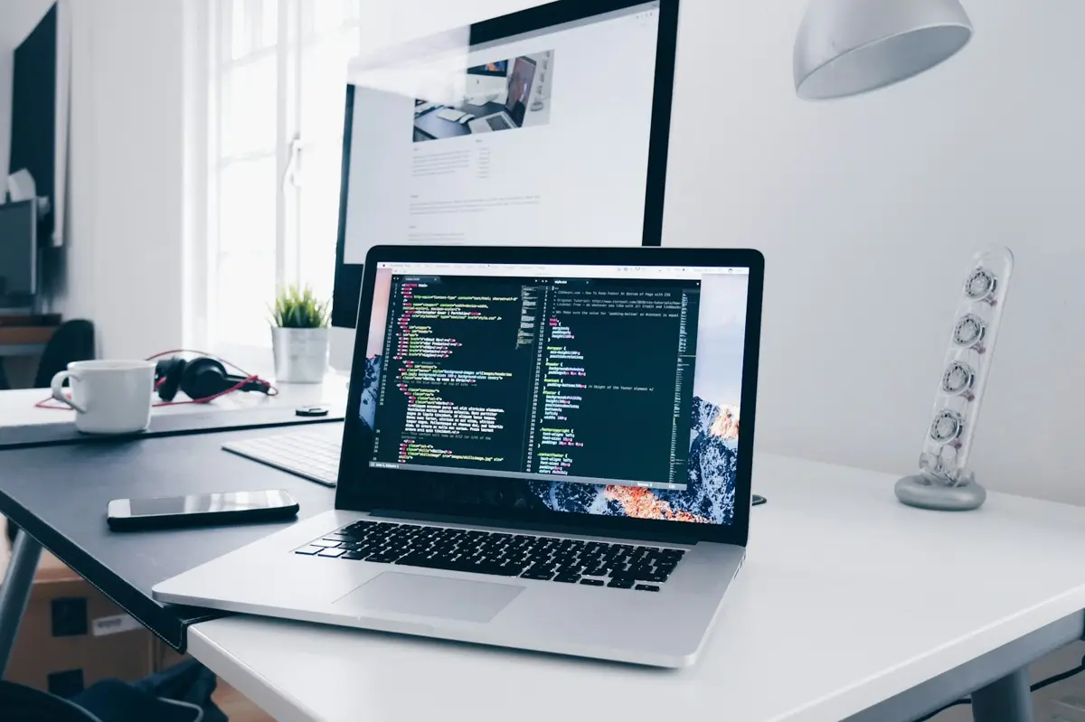 Developer workspace with laptop showing code